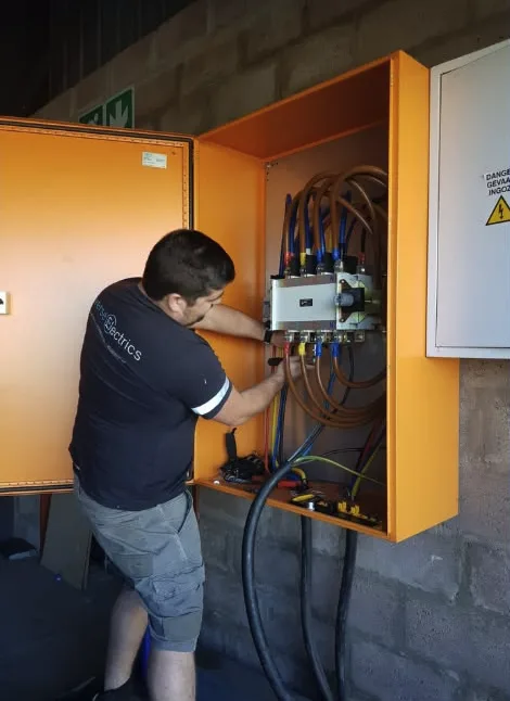 Diverse Electrics team member working on an electrical panel